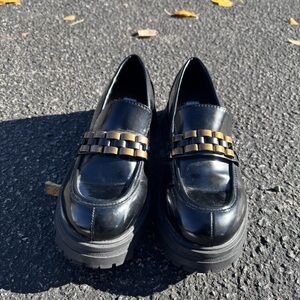 ARULA Shiny Black Loafers with Gold Accent